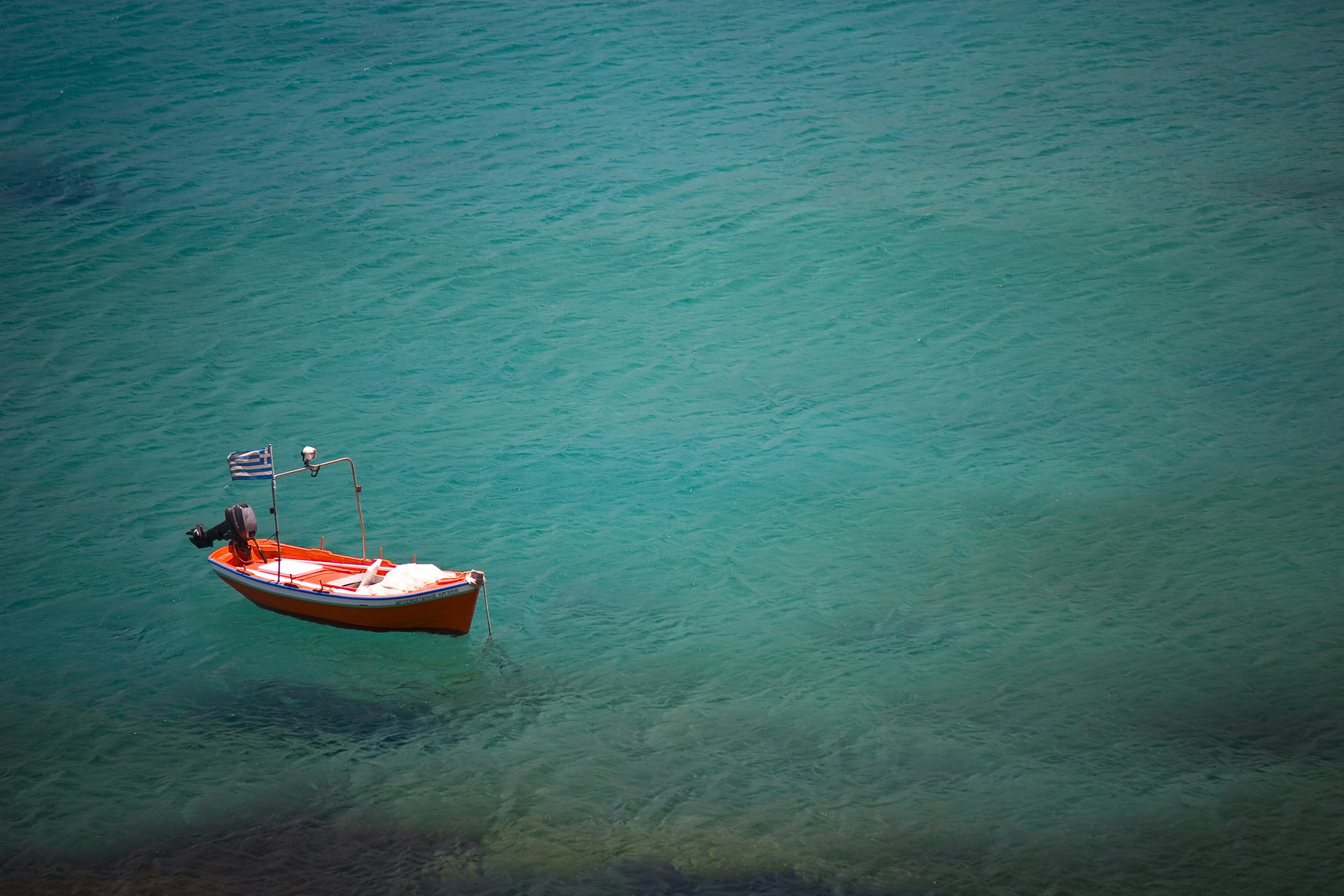 red boat on blue ocean during daytime